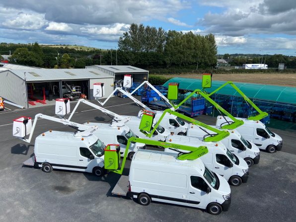 Numerous types of cherry picker vans with the basket/hoists lifted in to the air. taken in ireland in 2024, machines built in cherry picker ltd